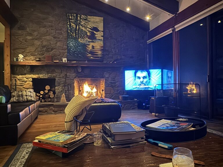 Stone-fireplace great room with a TV and surround sound
