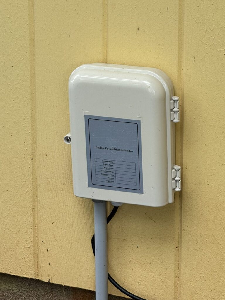 Weatherproof equipment enclosure mounted on exterior siding