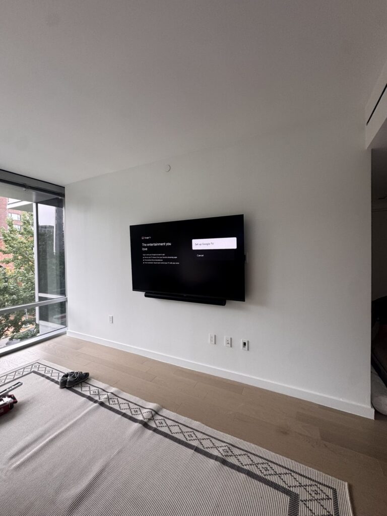Clean wall-mounted TV with hidden wiring in a bright room